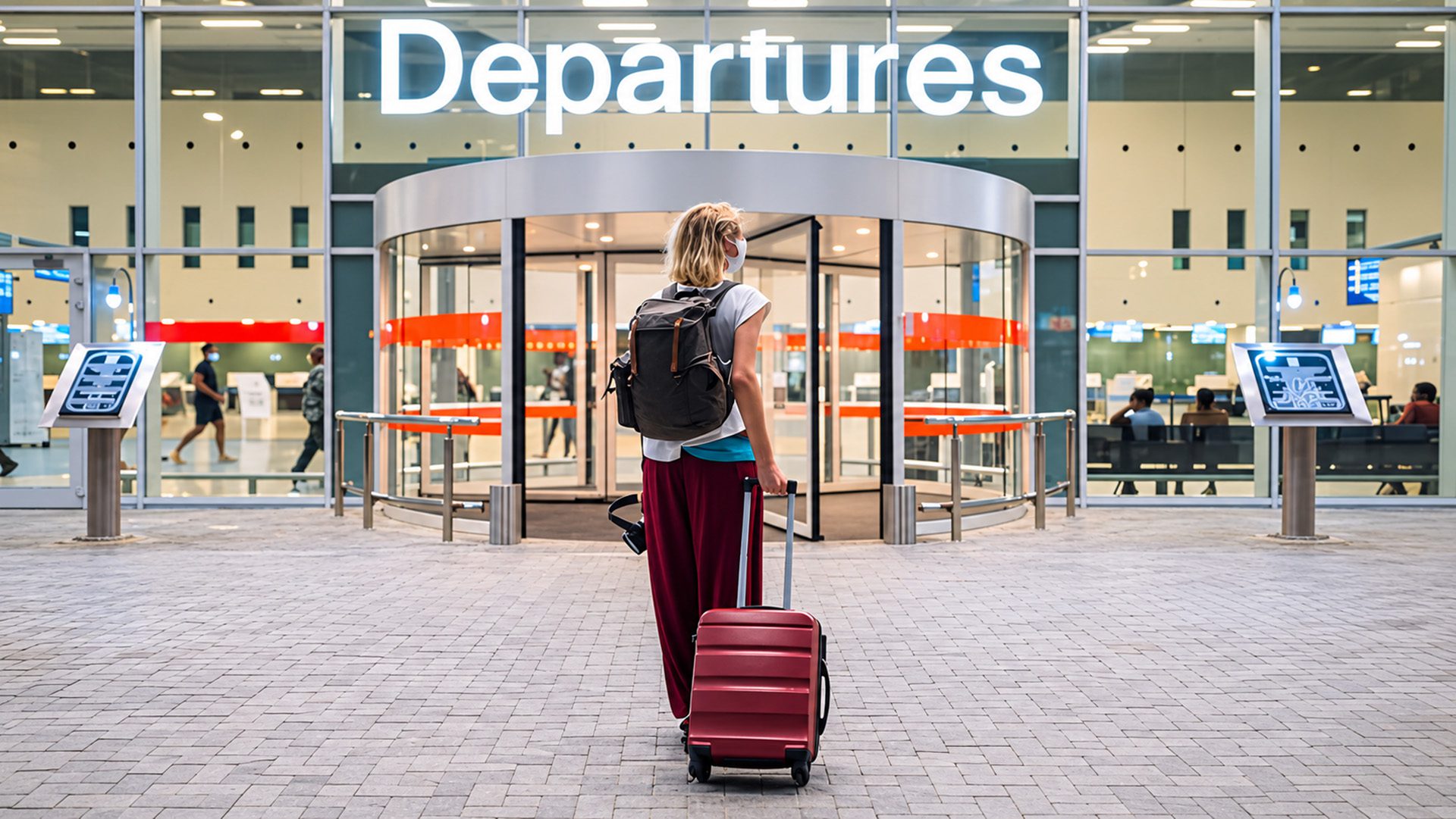 Airport departures with a red suitcase